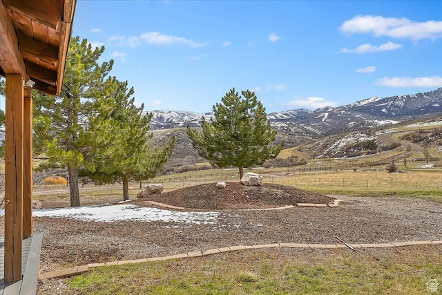 view of yard featuring a mountain view and fence