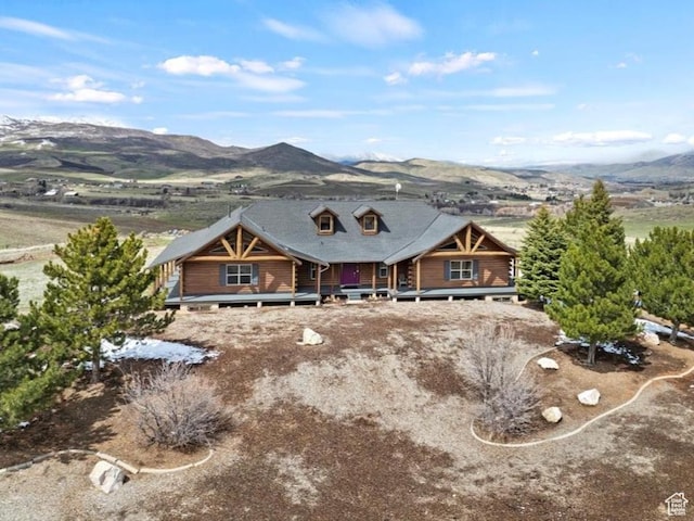 view of front of home featuring a deck with mountain view