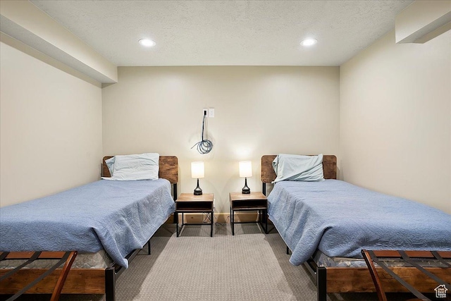 carpeted bedroom with recessed lighting and a textured ceiling