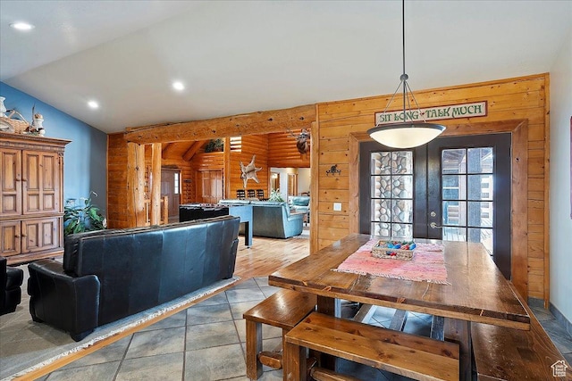 dining room featuring recessed lighting, wooden walls, and lofted ceiling