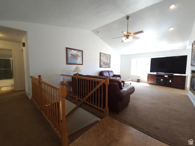 149 Toponce Dr, Evanston, WY 82930 - carpeted living room featuring a textured ceiling, a ceiling fan, and lofted ceiling