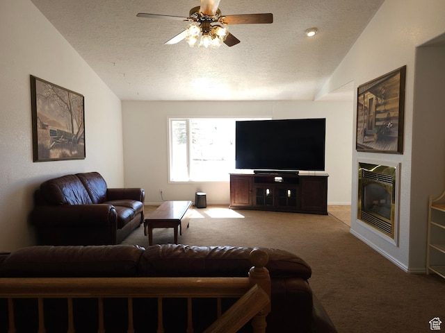 149 Toponce Dr, Evanston, WY 82930 - living room with a ceiling fan, a textured ceiling, vaulted ceiling, light colored carpet, and a glass covered fireplace