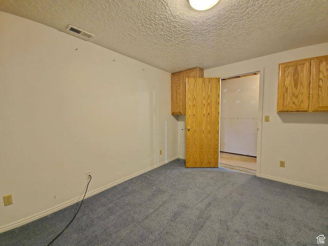 149 Toponce Dr, Evanston, WY 82930 - carpeted spare room with visible vents, baseboards, and a textured ceiling