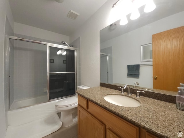 149 Toponce Dr, Evanston, WY 82930 - bathroom with shower / bath combination with glass door, vanity, visible vents, and toilet