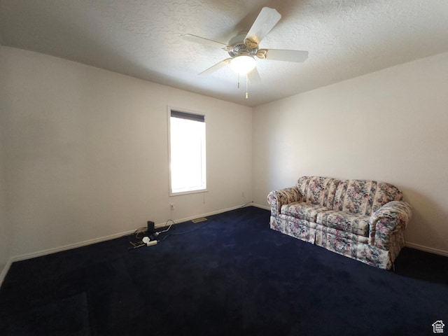 149 Toponce Dr, Evanston, WY 82930 - unfurnished room featuring dark colored carpet, a textured ceiling, baseboards, and ceiling fan
