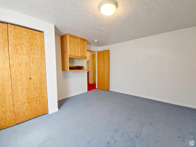 149 Toponce Dr, Evanston, WY 82930 - unfurnished living room featuring baseboards, carpet flooring, and a textured ceiling