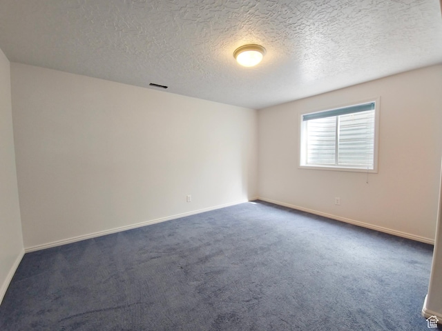 149 Toponce Dr, Evanston, WY 82930 - spare room with dark colored carpet, visible vents, and baseboards
