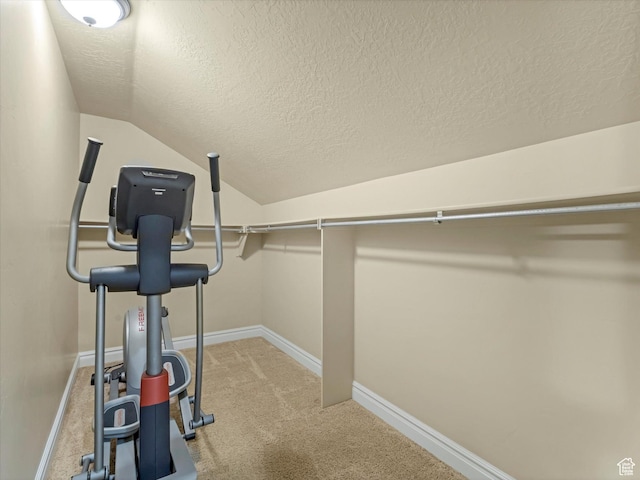 walk in closet featuring carpet floors and lofted ceiling