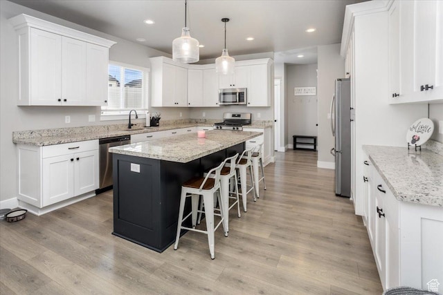 1379 E Hollyhock Ct, Layton, UT 84040 - kitchen with a sink, a center island, appliances with stainless steel finishes, and white cabinetry