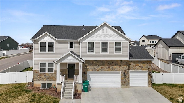1379 E Hollyhock Ct, Layton, UT 84040 - view of front of home with fence private yard, driveway, stone siding, central AC unit, and a gate