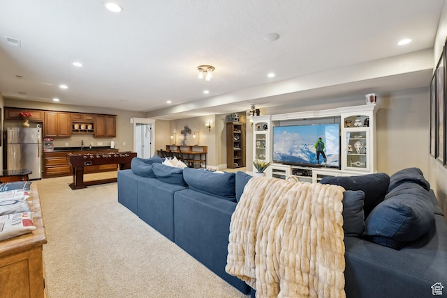 living area with light colored carpet, visible vents, and recessed lighting