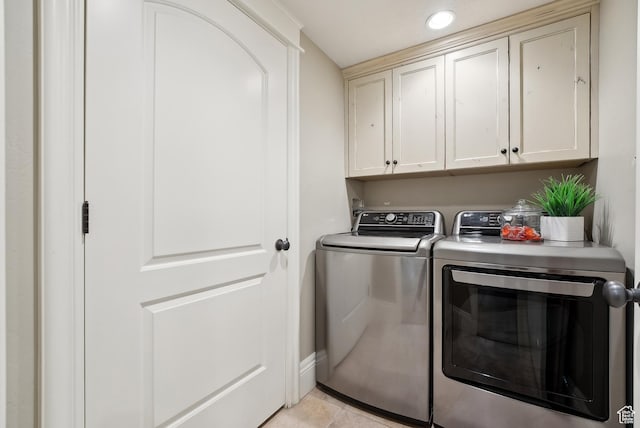 washroom with washing machine and dryer, recessed lighting, light tile patterned floors, baseboards, and cabinet space