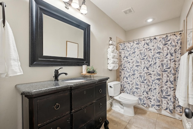 full bath featuring vanity, toilet, visible vents, and tile patterned floors