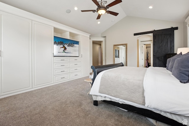 bedroom with a ceiling fan, recessed lighting, a barn door, carpet, and vaulted ceiling