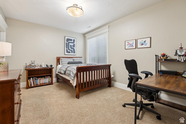 bedroom with light colored carpet and baseboards