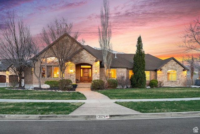 13075 S Summerharvest Dr E, Draper, UT 84020 - french country style house featuring stone siding, a front yard, and brick siding