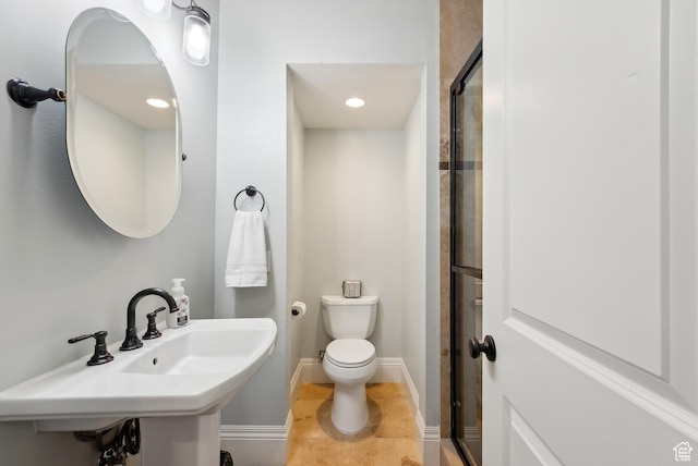 full bathroom featuring a shower stall, baseboards, tile patterned floors, and toilet