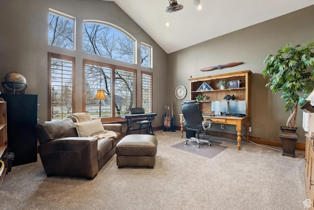 carpeted home office with baseboards and high vaulted ceiling