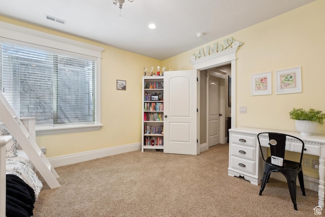home office with light colored carpet, baseboards, and visible vents
