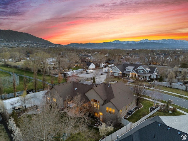aerial view at dusk with a mountain view and a residential view