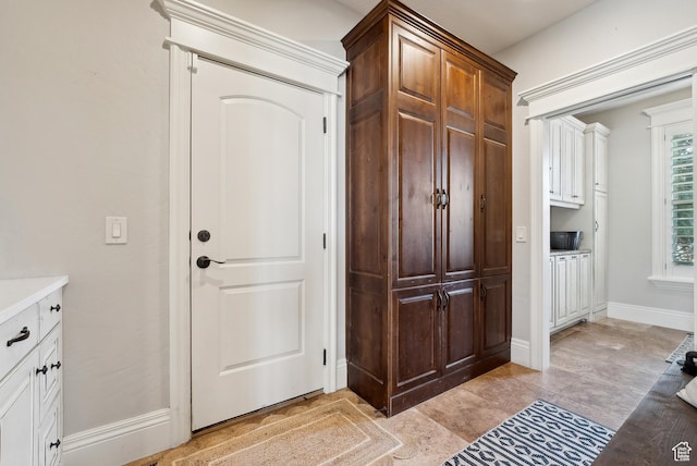 interior space featuring baseboards