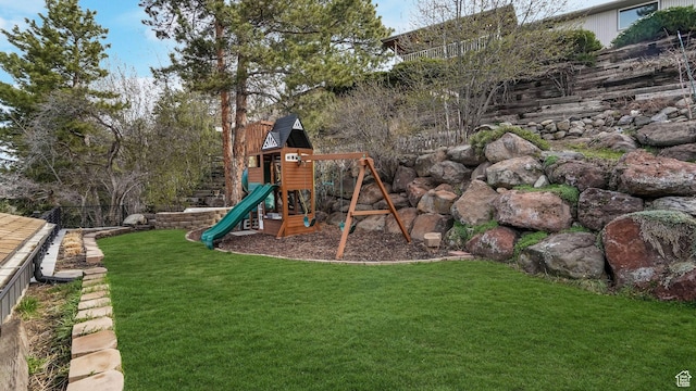 view of play area featuring fence and a lawn