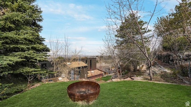view of yard with a fire pit