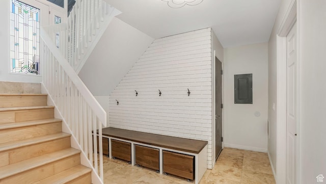 mudroom with brick wall and electric panel
