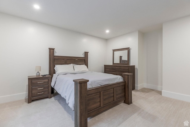 bedroom featuring recessed lighting, light colored carpet, and baseboards
