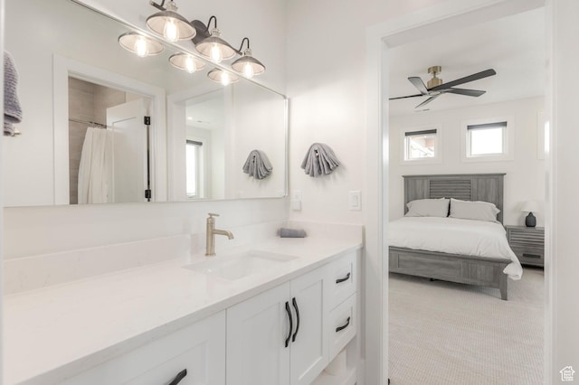 bathroom featuring ceiling fan, connected bathroom, vanity, and plenty of natural light