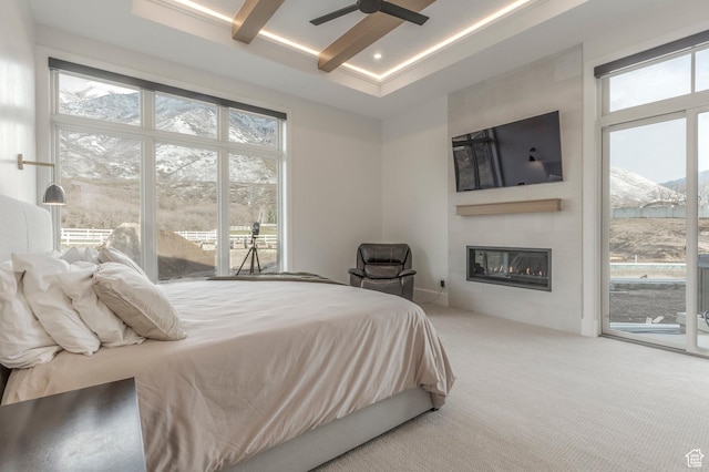 carpeted bedroom featuring a large fireplace, recessed lighting, access to exterior, beam ceiling, and ceiling fan