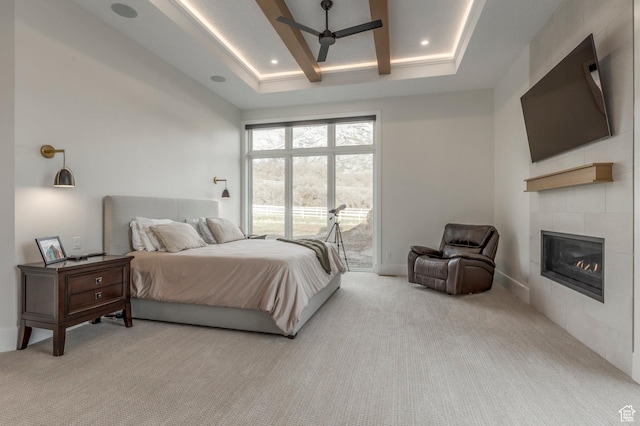 bedroom with access to outside, baseboards, light carpet, a tiled fireplace, and recessed lighting