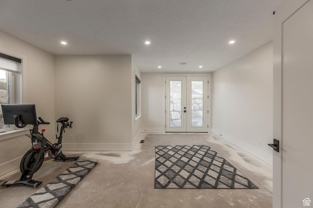 workout area with a wealth of natural light, recessed lighting, french doors, and baseboards