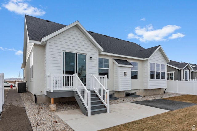 692 W Junegrass Ln, Stansbury Park, UT 84074 - back of property featuring a patio area, central AC, fence, and a shingled roof