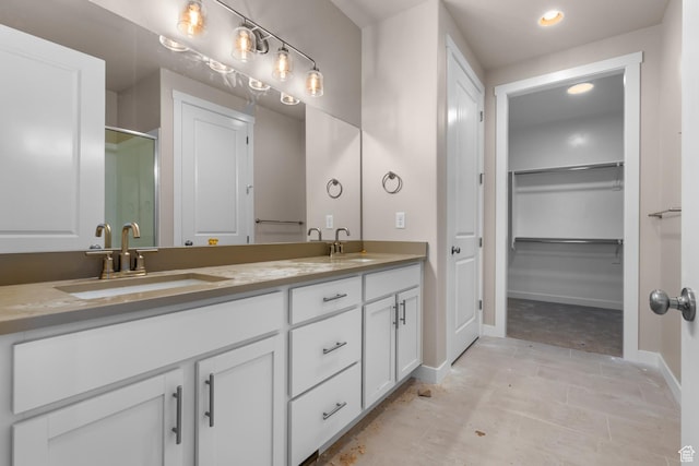 692 W Junegrass Ln, Stansbury Park, UT 84074 - full bathroom with a stall shower, double vanity, a sink, and baseboards