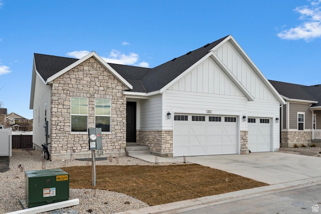 692 W Junegrass Ln, Stansbury Park, UT 84074 - view of front facade featuring board and batten siding, an attached garage, stone siding, and concrete driveway
