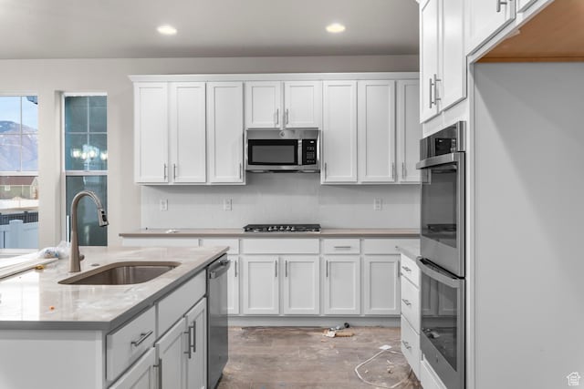 692 W Junegrass Ln, Stansbury Park, UT 84074 - kitchen with tasteful backsplash, recessed lighting, white cabinets, stainless steel appliances, and a sink