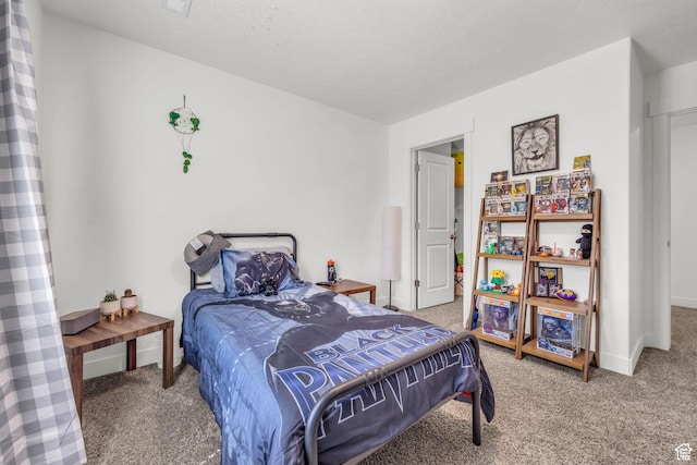 bedroom with carpet floors and baseboards