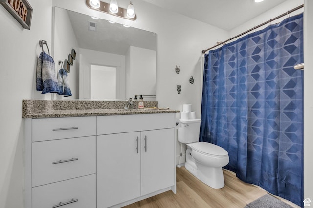 full bath with vanity, visible vents, toilet, wood finished floors, and a shower with shower curtain