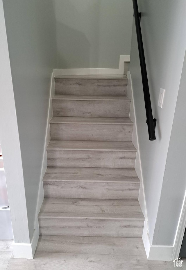 stairway featuring baseboards