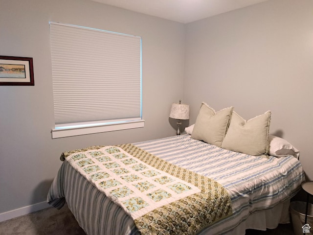 carpeted bedroom featuring baseboards