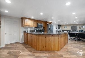 3184 N Timpview Dr N, Provo, UT 84604 - kitchen with light wood-style flooring, a peninsula, recessed lighting, and stainless steel appliances