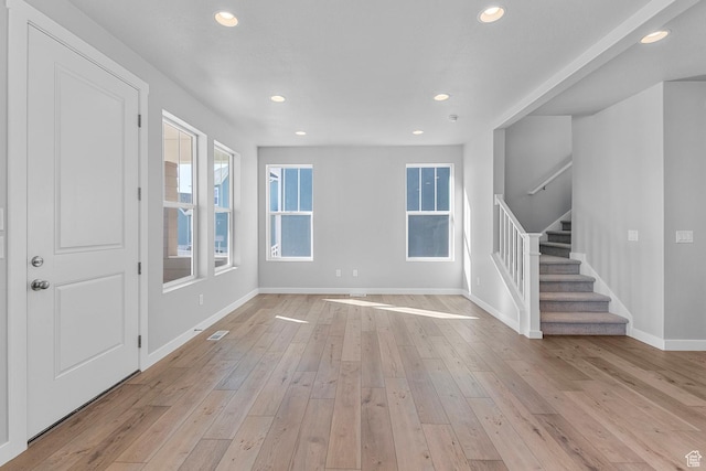 7021 W Granbury Dr, South Jordan, UT 84009 - unfurnished living room featuring recessed lighting, light wood finished floors, stairway, and baseboards