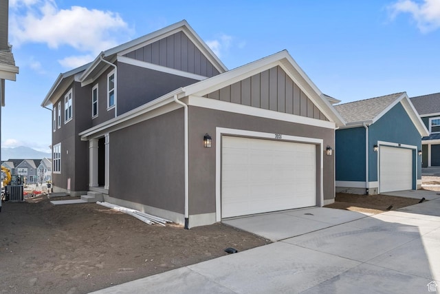7021 W Granbury Dr, South Jordan, UT 84009 - view of side of home featuring a garage, central AC unit, driveway, and board and batten siding