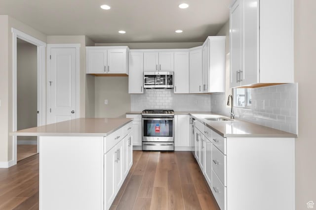 11838 S Golden Pine Ln, Riverton, UT 84065 - kitchen featuring white cabinetry, recessed lighting, wood finished floors, a sink, and stainless steel appliances