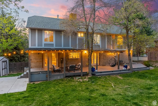 3338 E Creek Rd, Cottonwood Heights, UT 84121 - back of house featuring a hot tub, a shed, brick siding, roof with shingles, and a wooden deck