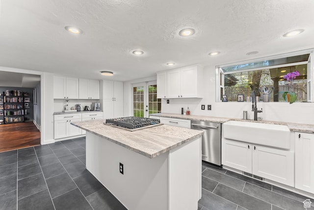 3338 E Creek Rd, Cottonwood Heights, UT 84121 - kitchen with appliances with stainless steel finishes, a textured ceiling, white cabinets, light stone counters, and recessed lighting
