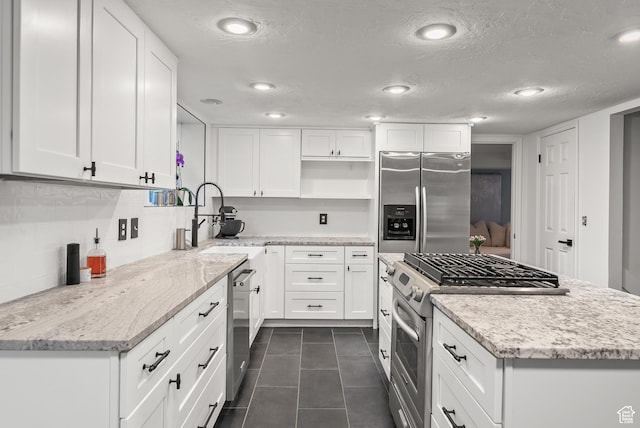 3338 E Creek Rd, Cottonwood Heights, UT 84121 - kitchen with open shelves, stainless steel appliances, a kitchen island, dark tile patterned floors, and white cabinetry