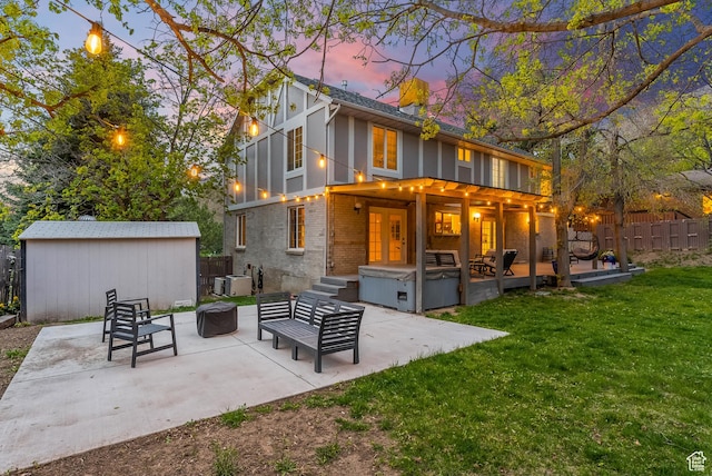 3338 E Creek Rd, Cottonwood Heights, UT 84121 - rear view of house with a patio area, brick siding, a fenced backyard, an outdoor living space with a fire pit, and a hot tub