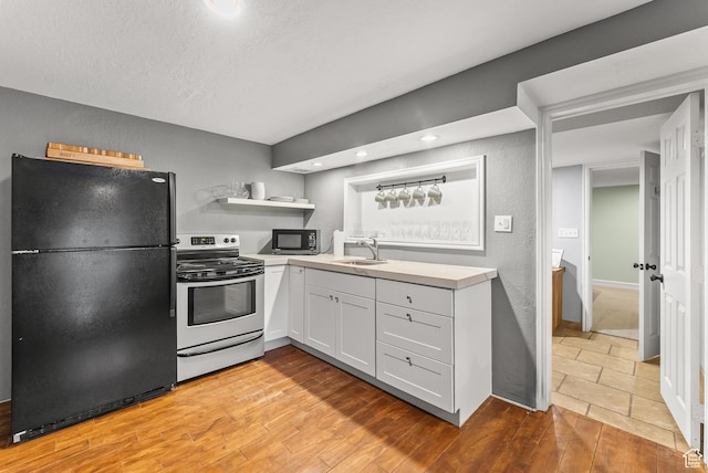 3338 E Creek Rd, Cottonwood Heights, UT 84121 - kitchen featuring black appliances, light countertops, light wood finished floors, open shelves, and white cabinetry